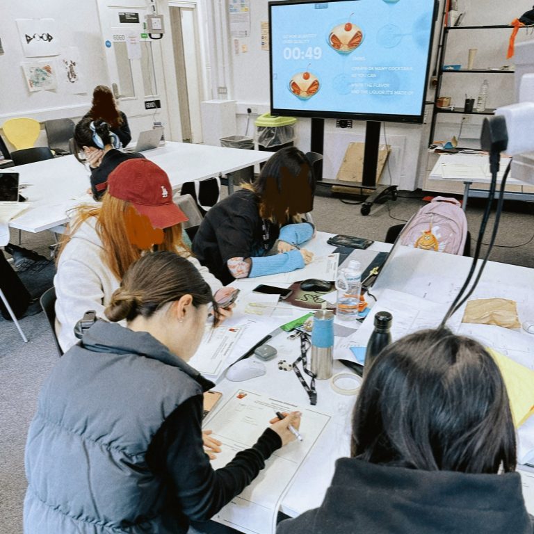 Students working with the handouts. In the background, the instructions are also in the presentation